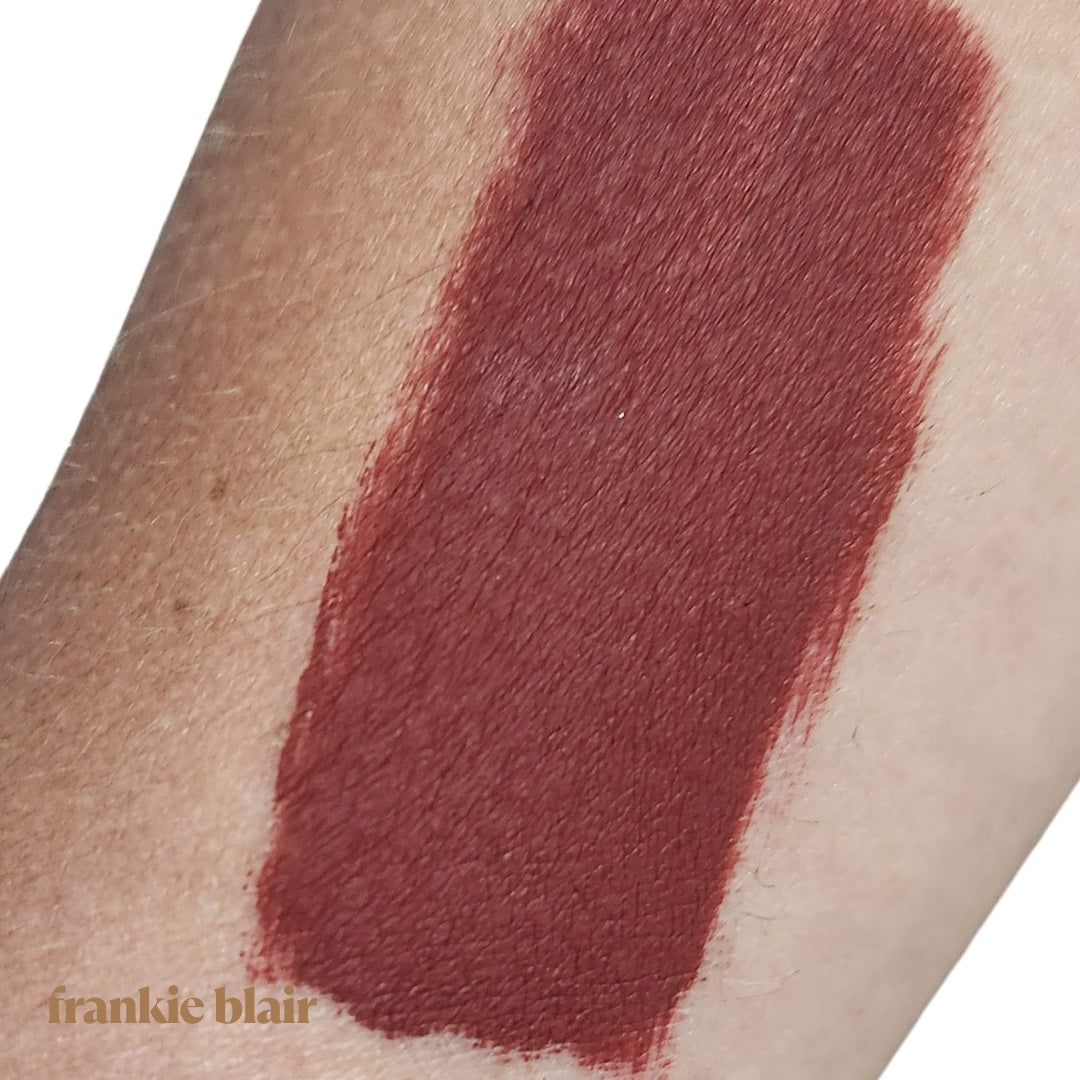 Frankie Blair Desert Rani Matte Lip Stain Swatch on Arm, A reddish brown lip stain that is long lasting and hydrating.