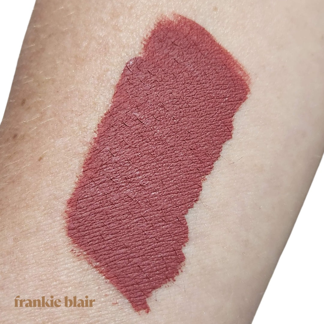 A swatch of Frankie Blair's Matte Lip Stain, Everly, on an arm. A Desert Rose Brown Liquid Lipstain. The best lip stain for a long lasting and hydrated lip.
