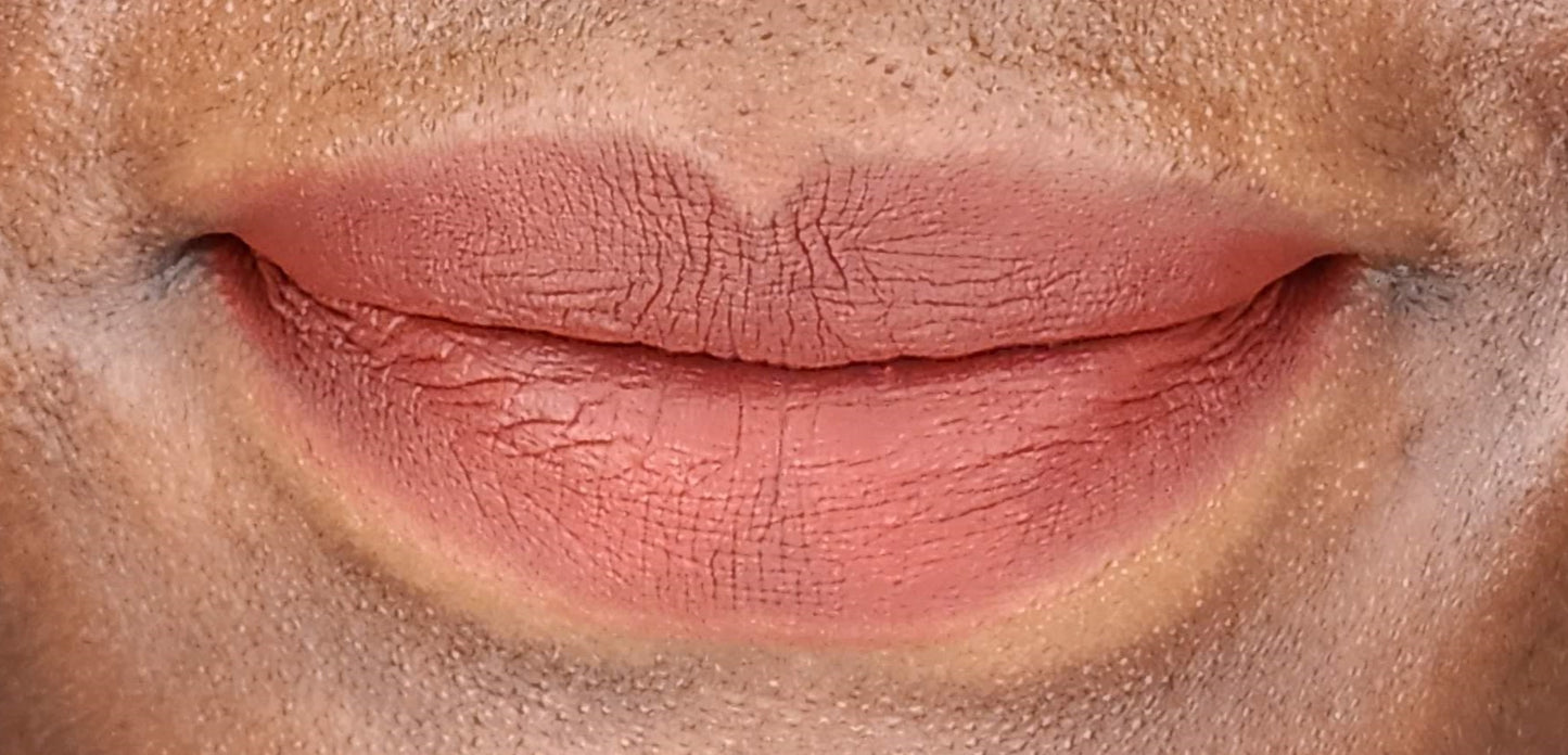 Women wearing Frankie Blair Desert Rani Matte Lip Stain, A reddish brown lip stain that is long lasting and hydrating.