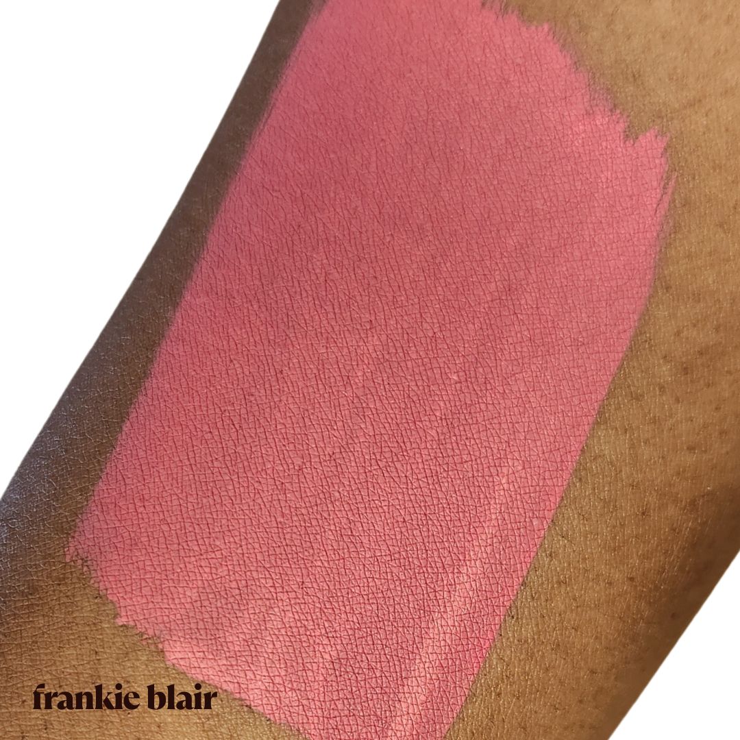 Frankie Blair Almadine Matte Lip Stain swatch on arm, A deep bright pink lip stain.