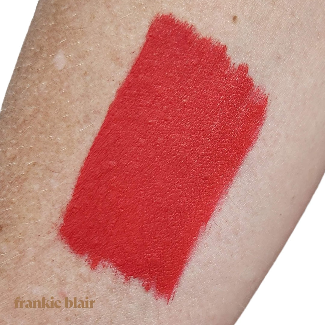 Frankie Blair Rubor Red Matte Lip Stain swatch on arm, a bright dramatic red lip stain. Long lasting and hydrating.