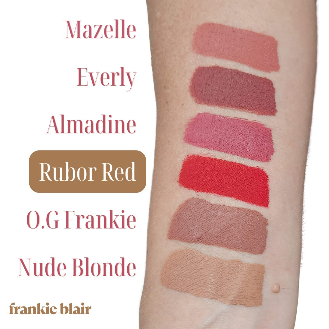 Frankie Blair Matte Lip Stain swatch on arm highlighting Rubor Red