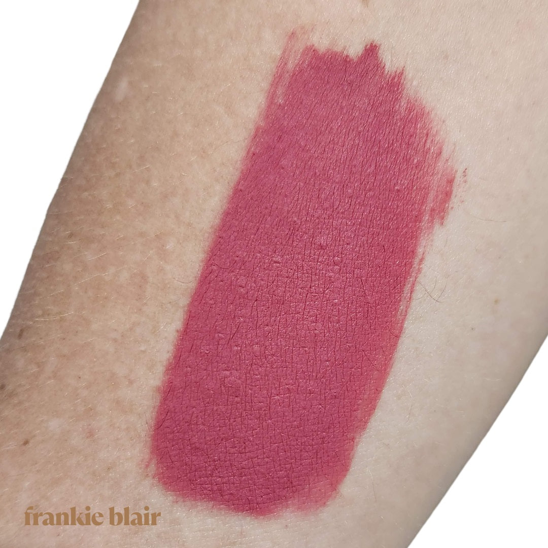 Frankie Blair Almadine Matte Lip Stain swatch on Arm, a deep bright pink lip stain.