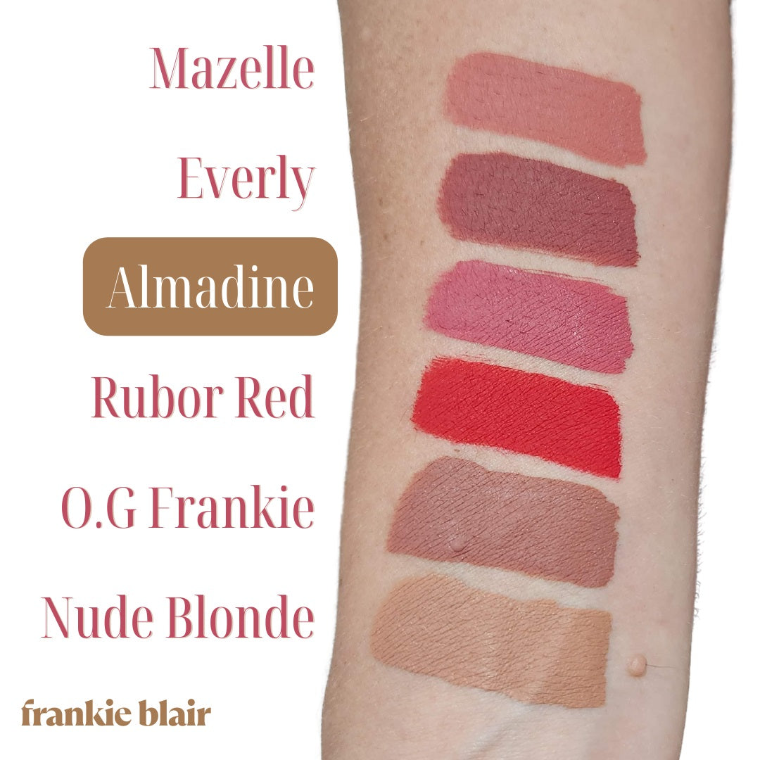 Arm swatch of Frankie Blair Matte Lip Stains highlighting Almadine