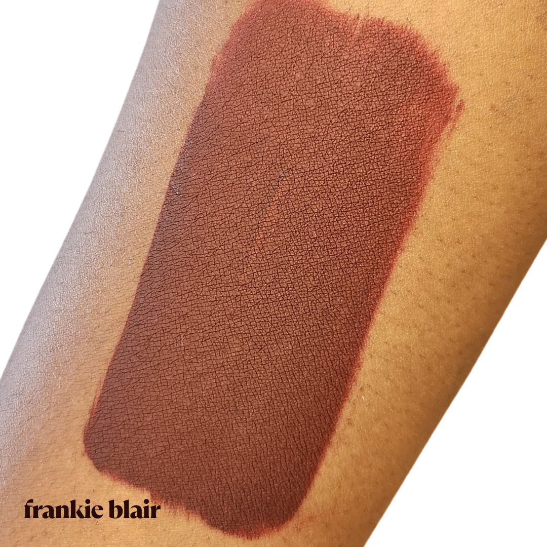 Frankie Blair Lennox Matte Lip Stain swatch on arm, a dark chocolate brown with berry undertone lip stain.