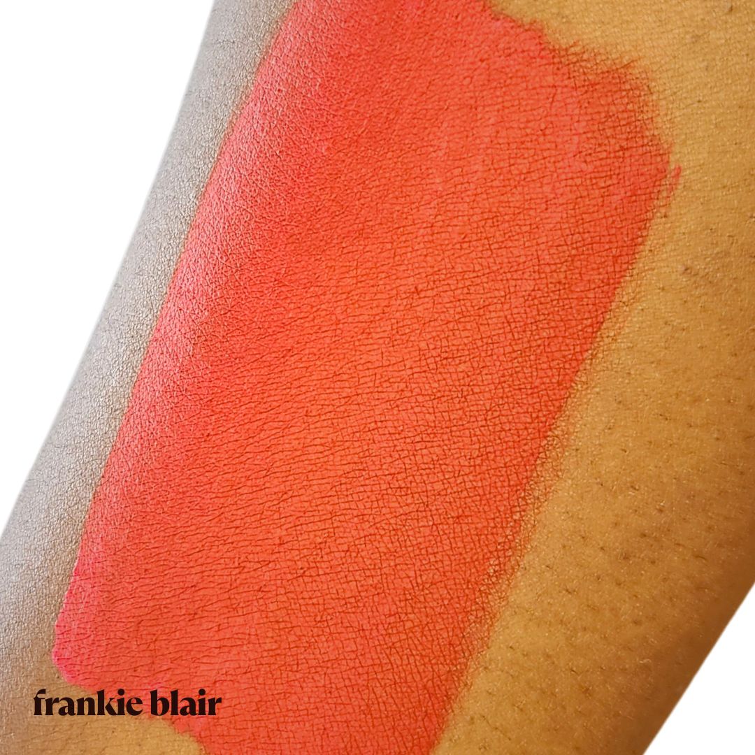 Frankie Blair Matte Lip Stain Rubor Red swatch on arm, a bright dramatic red lip stain. Long lasting and hydrating.